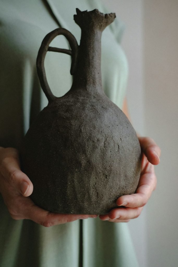 Person Holding Brown Ceramic Vase Xfusknynko 683x1024